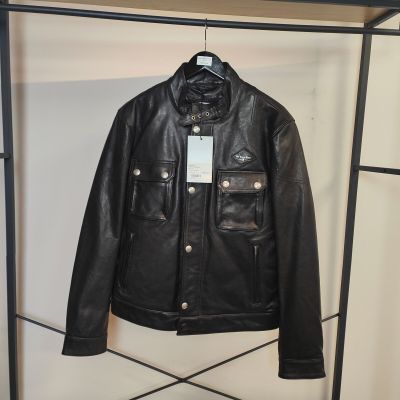 une veste en cuir noir accrochée à un portant dans une pièce