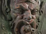 a close up of a face on a green door