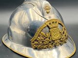 a silver helmet with a gold emblem on it
