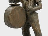 bronze statue of a boy with a drum and a bowl