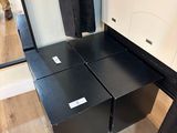 a black and white closet with two drawers and a mirror