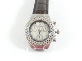 une image d'un gros plan d'une montre-bracelet sur une surface blanche