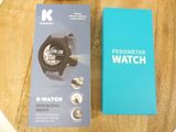 packaging for a watch on a wooden table with a blue box
