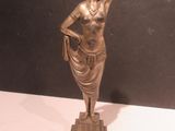 a statue of a woman that is standing on a table