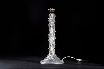 an image of a glass table lamp on a black surface