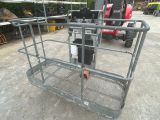 a large metal cage with a fork attached to it
