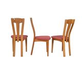 pair of wooden chairs with red upholstered seat cushions