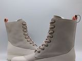 a close up of a pair of white boots on a white surface