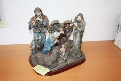 a figurine of a group of people sitting on a table