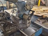 a machine that is working on a piece of wood