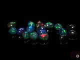 a close up of a group of oplite beads on a black surface