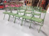 many green folding chairs in a room with pink chairs
