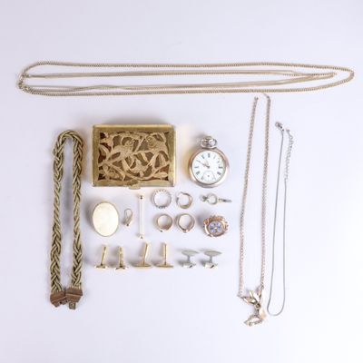 many different types of jewelry laid out on a white surface