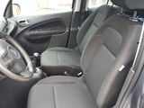 the interior of a car with the door open and the driver ' s seat down