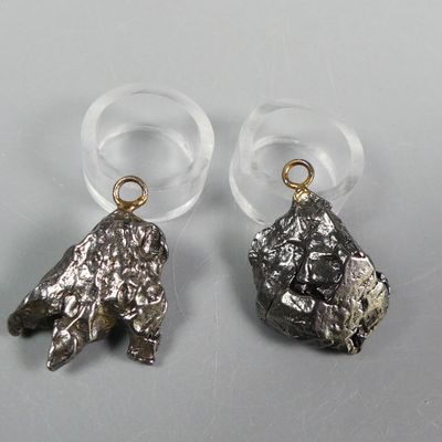 pair of silver and gold earrings on a white surface