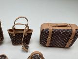 four pieces of louis vuitton purses with handles and handles