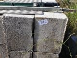 a pile of concrete blocks sitting in the middle of a field