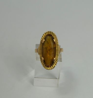 yellow tiger eye stone ring on clear acrylic stand