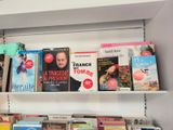 many books that are on the shelves in the room