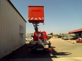 a red crane that is sitting on the back of a truck