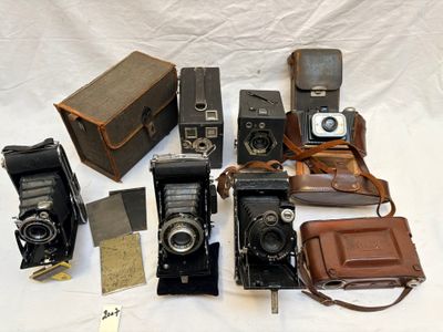 un tas de vieux appareils photo posés sur une table
