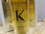 two bottles of kerastase hair oil sitting on a table