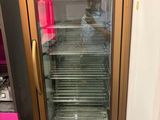 an image of a glass door refrigerator in a kitchen