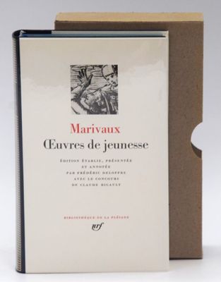 the book is open and sitting on the table next to the box