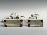 two figurines of a horse and a dog on display