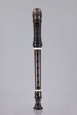 a close up of a flute on a table with a gray background