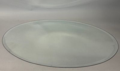 a white sink with a round mirror on it