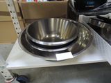 a metal bowl sitting on a shelf in a store