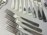 a lot of silver spoons and forks on the table