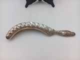 a silver spoon and a silver spoon on a white table