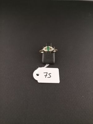 a close up of a ring on a table with a price tag