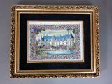 painting of a castle in a gold frame hanging on a wall