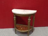 a small table with a marble top on a carpeted floor
