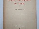 an old book with red writing on it sitting on a table
