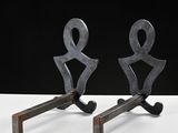 pair of metal sculptures of a man and a woman on a stand