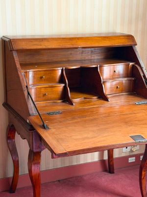 a wooden desk with a drawer on top of it