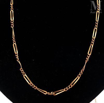 a gold chain necklace with a large link on a mannequin neck