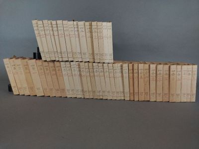many books stacked on top of each other on a table