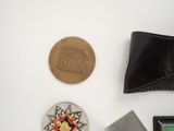 a wallet, a coin, and a card case on a table