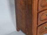 an image of a small wooden chest of drawers on a white background