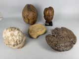 four different types of rock and stone on a white surface