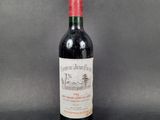 a bottle of red wine sitting on top of a table