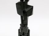 statue of a man holding a knife in his right hand on a white surface