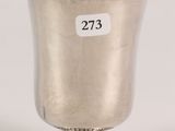 a close up of a silver cup on a pedestal with a price tag