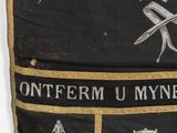 a black and gold banner with a picture of a man holding a sword