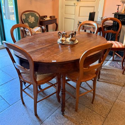 a table and chairs in a room with tile flooring